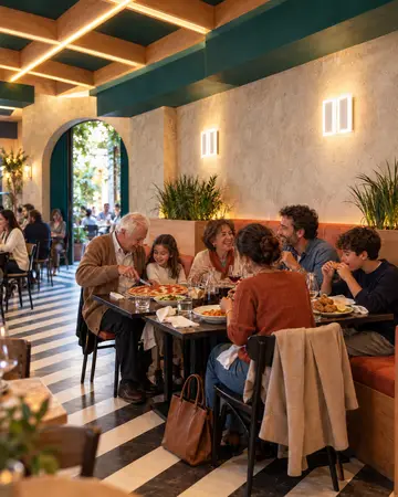 Tre generazioni a pranzo la domenica, il nonno taglia la pizza alla nipote.